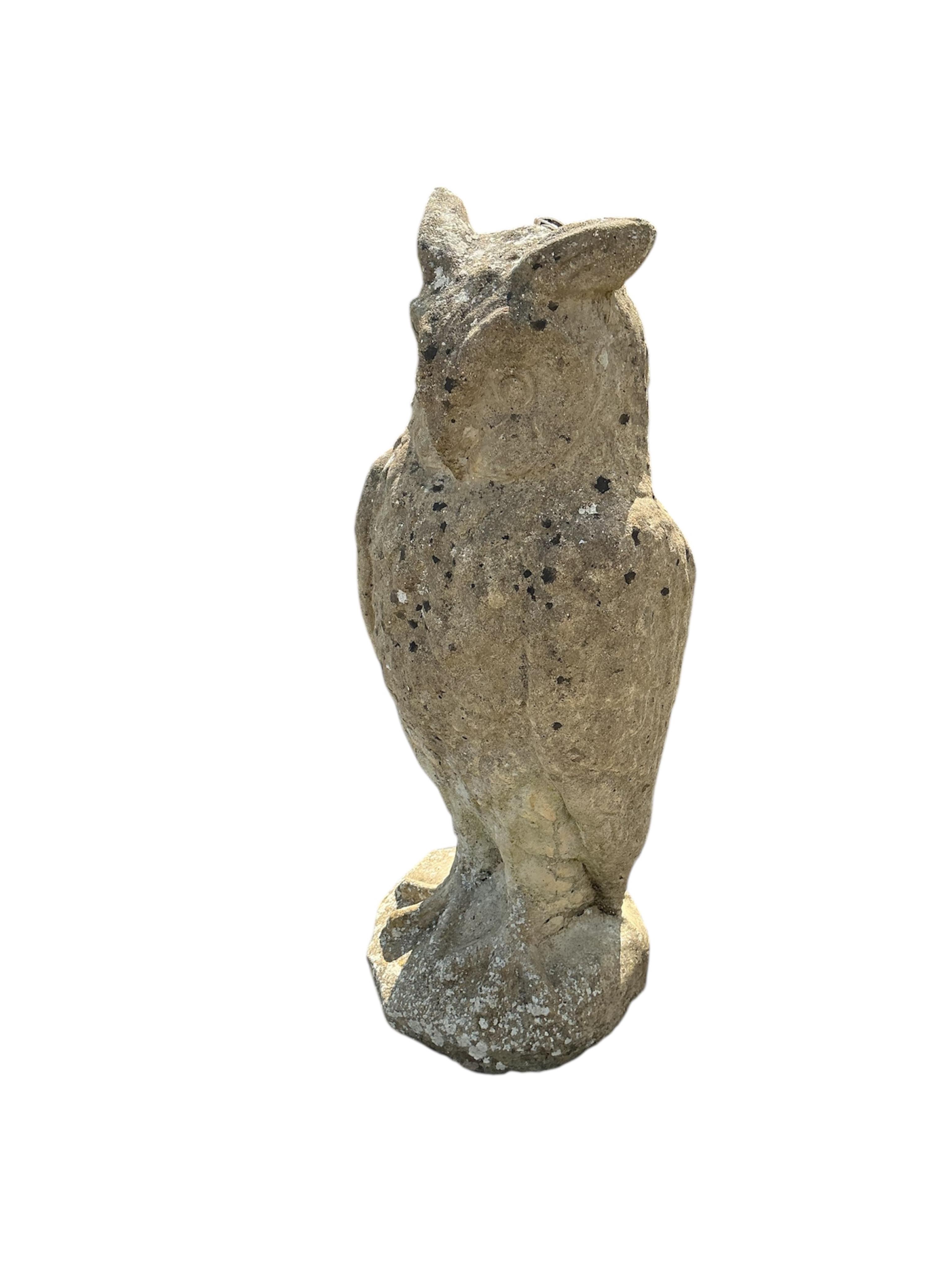 A reconstituted stone owl garden ornament, height 72cm